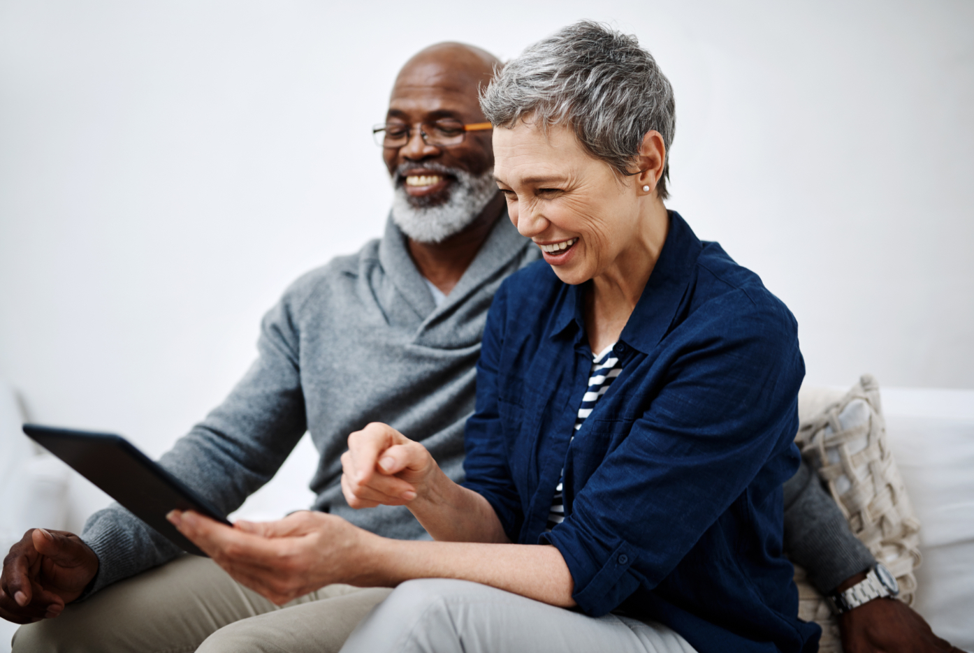 Shot of an affectionate senior couple using a tablet while relaxing on the sofa at home